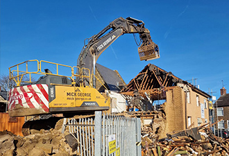 Mick George construction demolition showing a grabber onsite